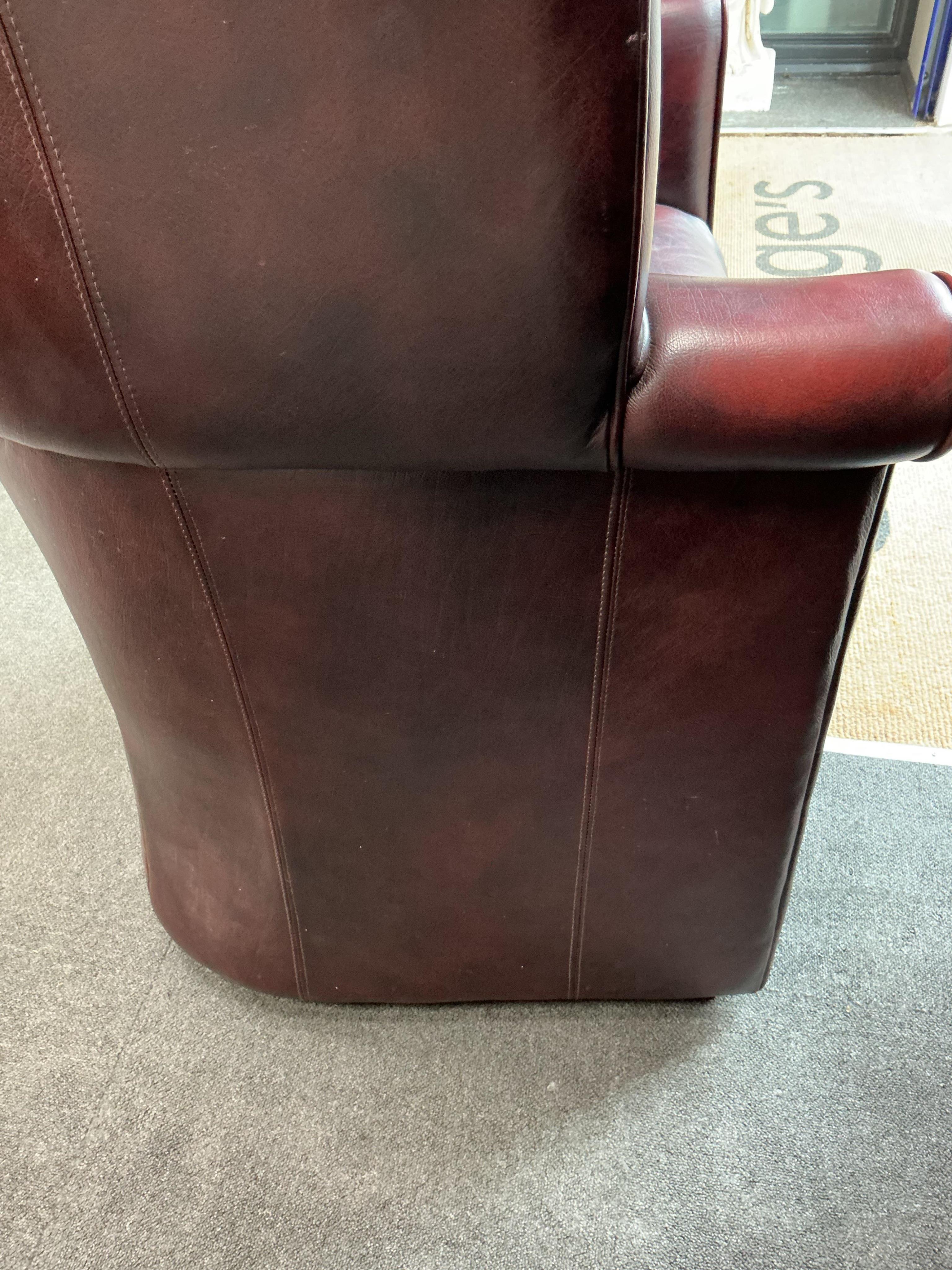 A reproduction buttoned burgundy leather hall porter's chair, width 88cm, depth 64cm, height 176cm